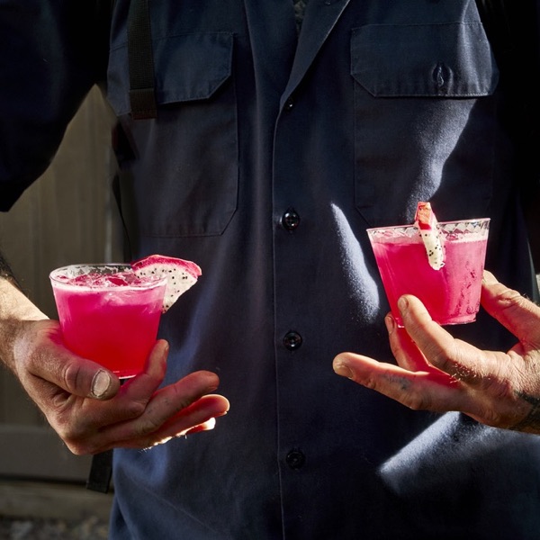 Two pink cocktails with dragon fruit garnish
